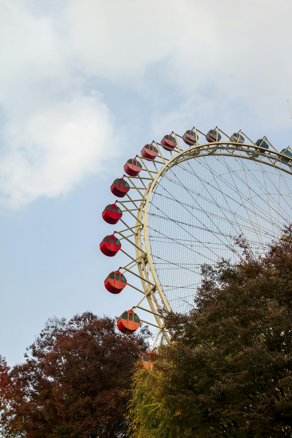 a ferris wheel with red lanterns hanging from it