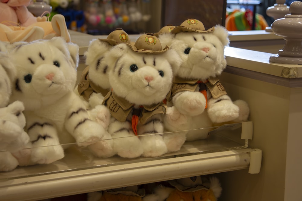 several stuffed animals on a shelf in a store