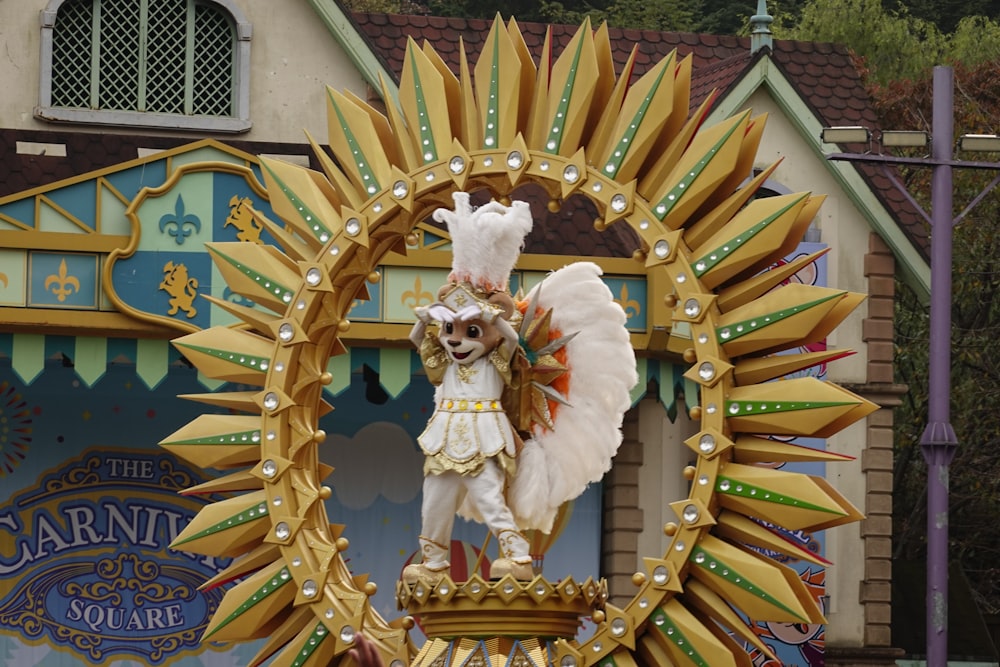 a statue of a man in a costume on top of a building