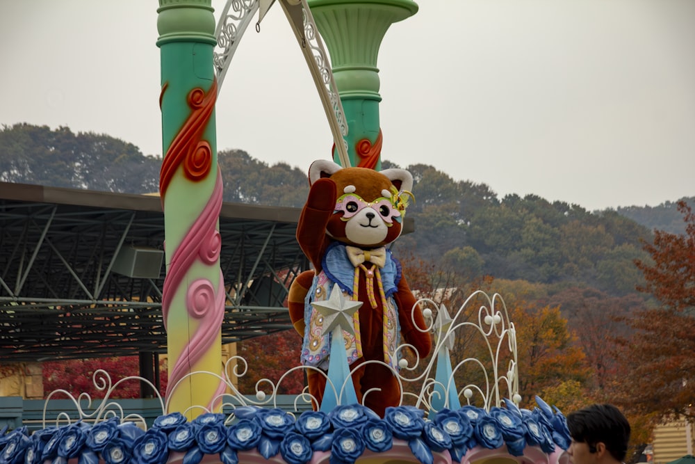 a carnival float with a teddy bear on top of it