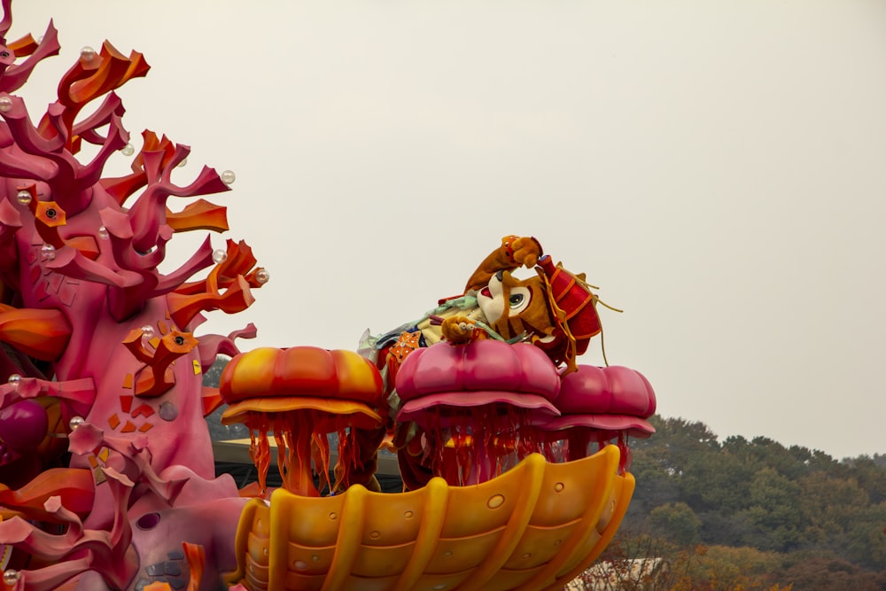 a carnival ride with colorful decorations on top of it