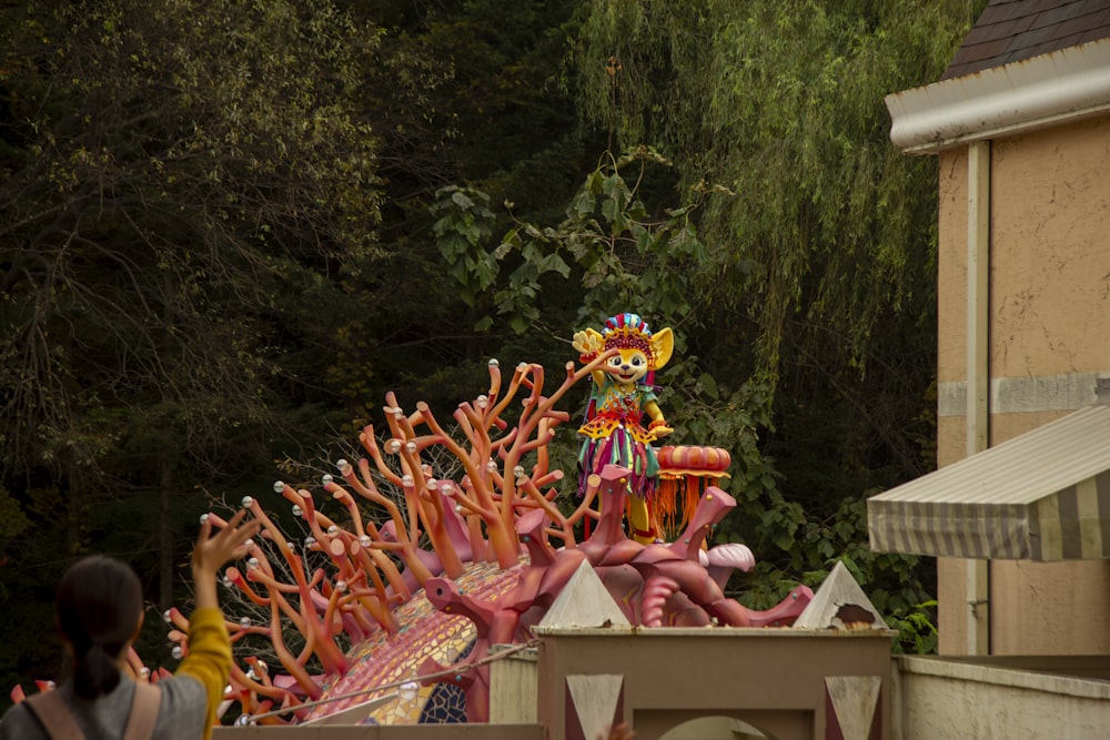 a carnival float with a clown on top of it