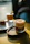 Close-up of a frothy coffee and colorful shake served on a glowing gold tray.