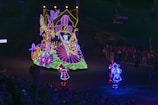 Nighttime carnival parade illuminated by colorful lights in Alfredo Chaves