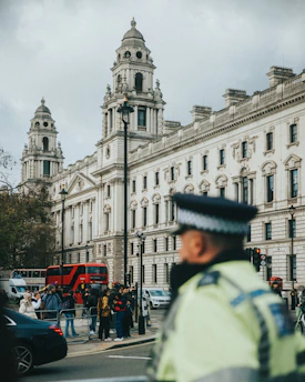 a police officer standing in front of a large building