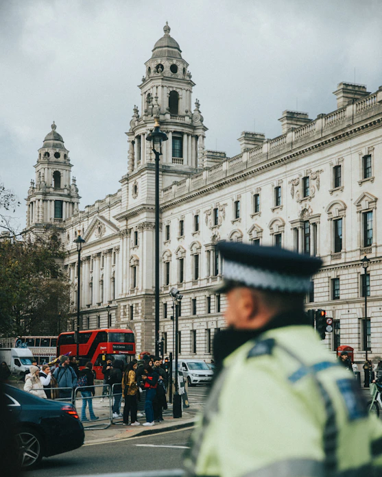 a police officer standing in front of a large building