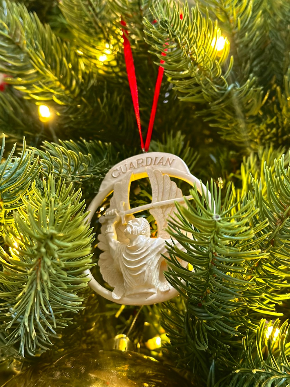 a christmas ornament hanging from a christmas tree