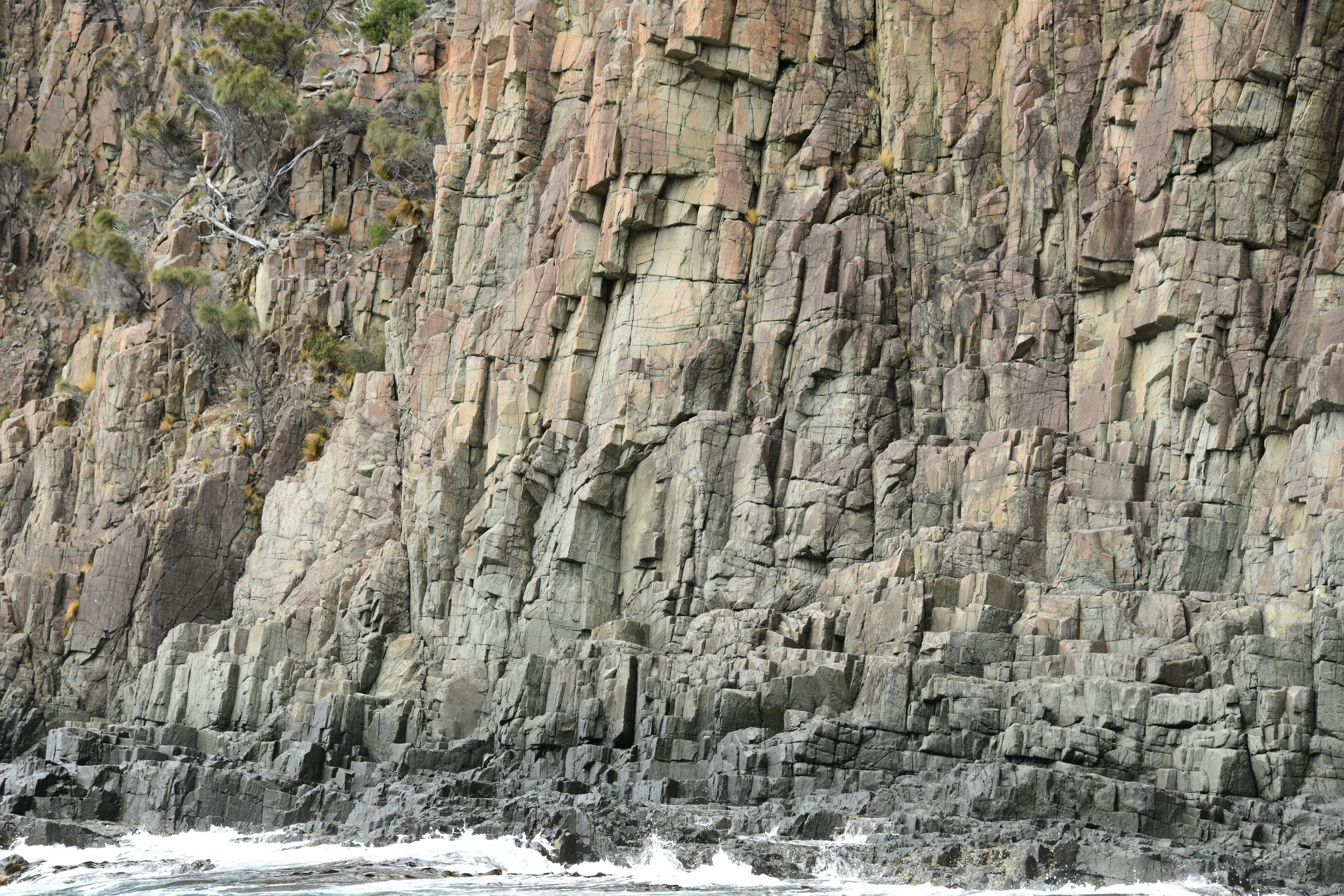 a man riding a surfboard on top of a body of water
