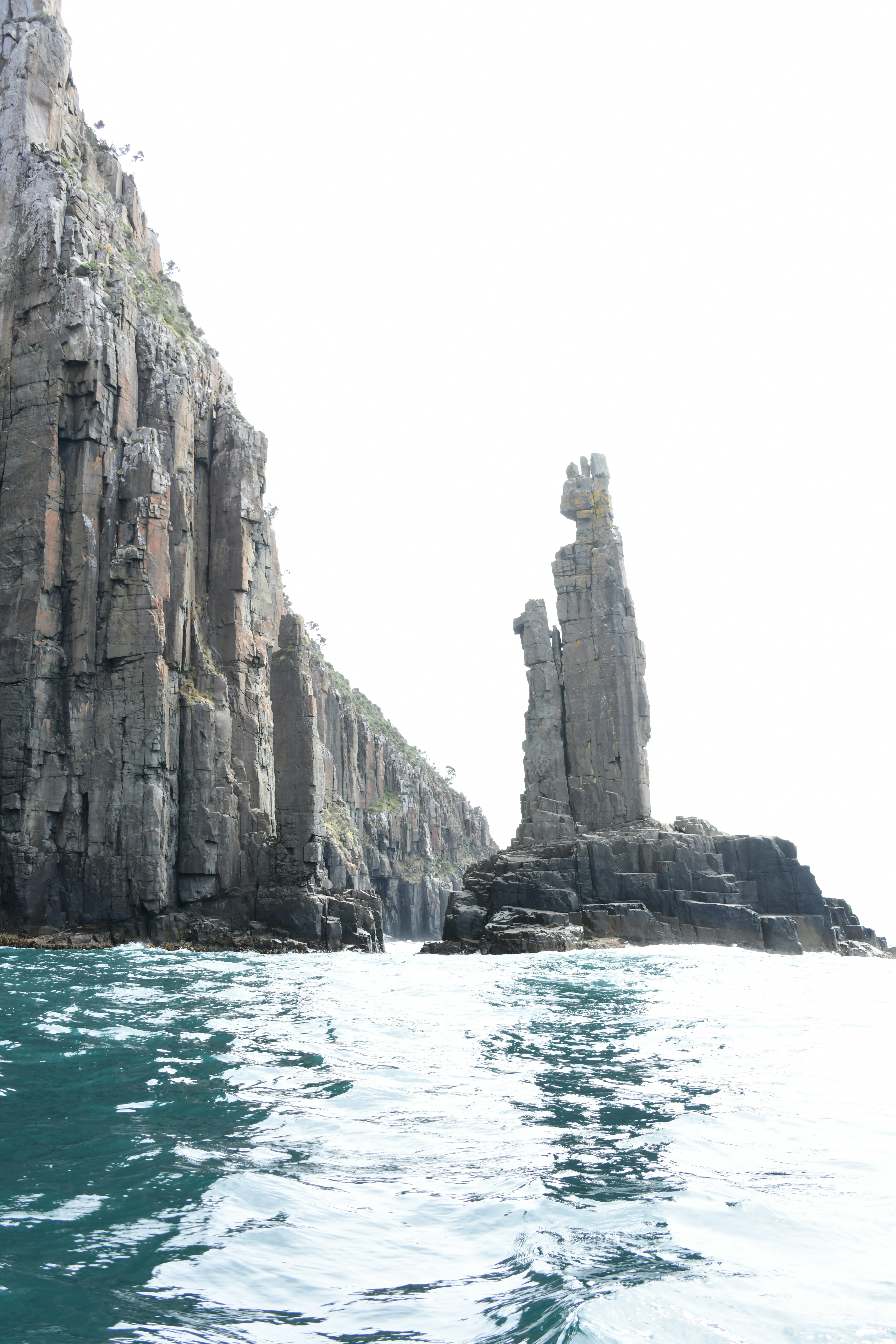 a body of water with rocks on the side of it