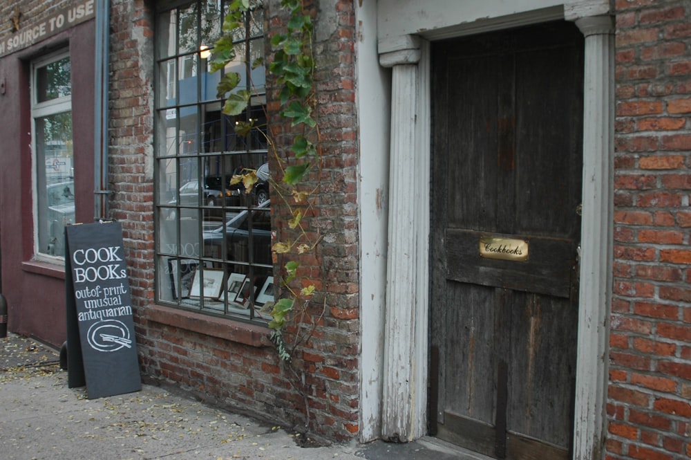 a brick building with a wooden door and window