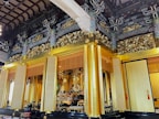 An elegant wooden temple adorned with intricate carvings.
