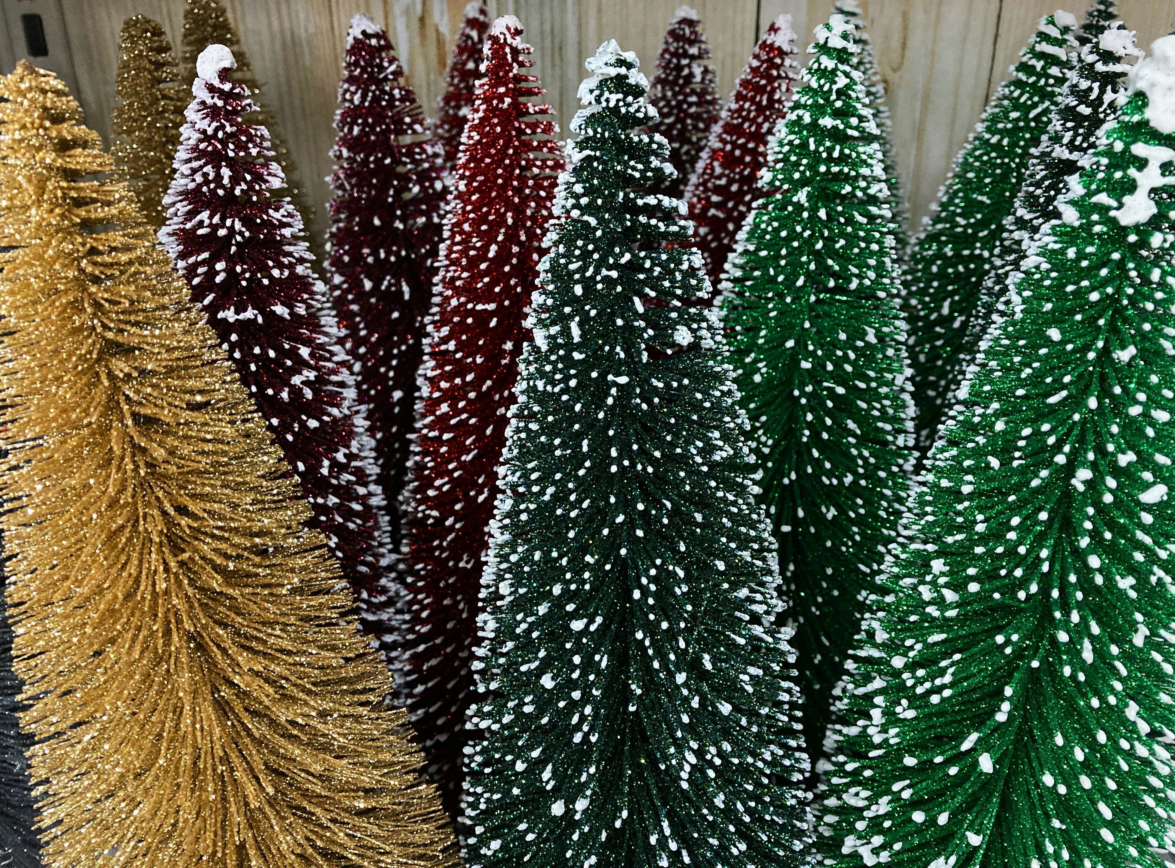 a group of christmas trees sitting next to each other
