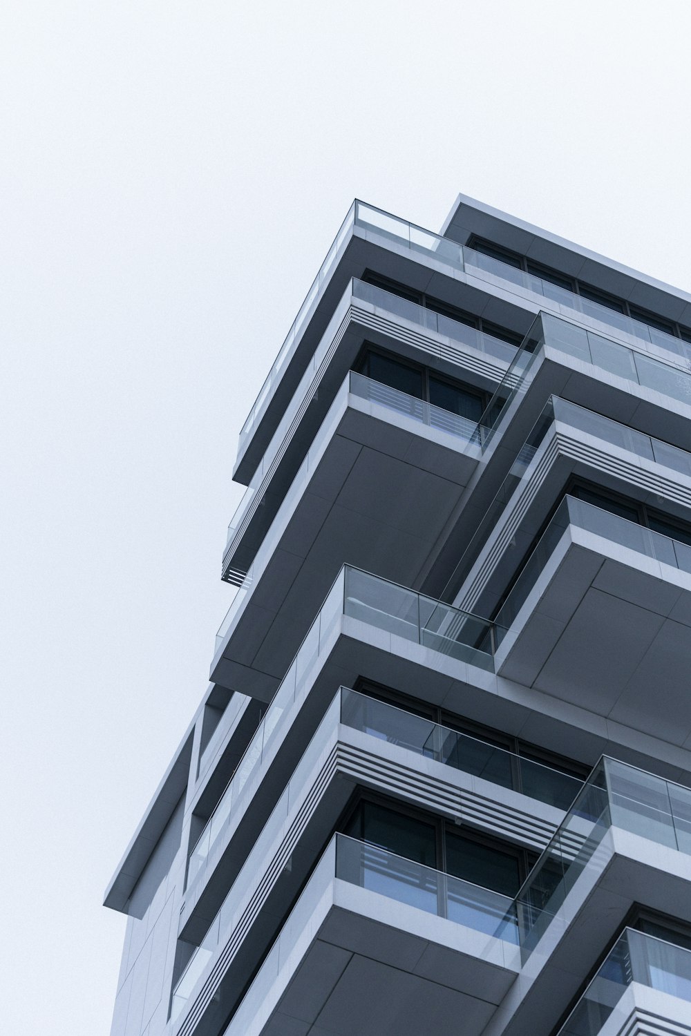 a tall building with balconies on the top of it