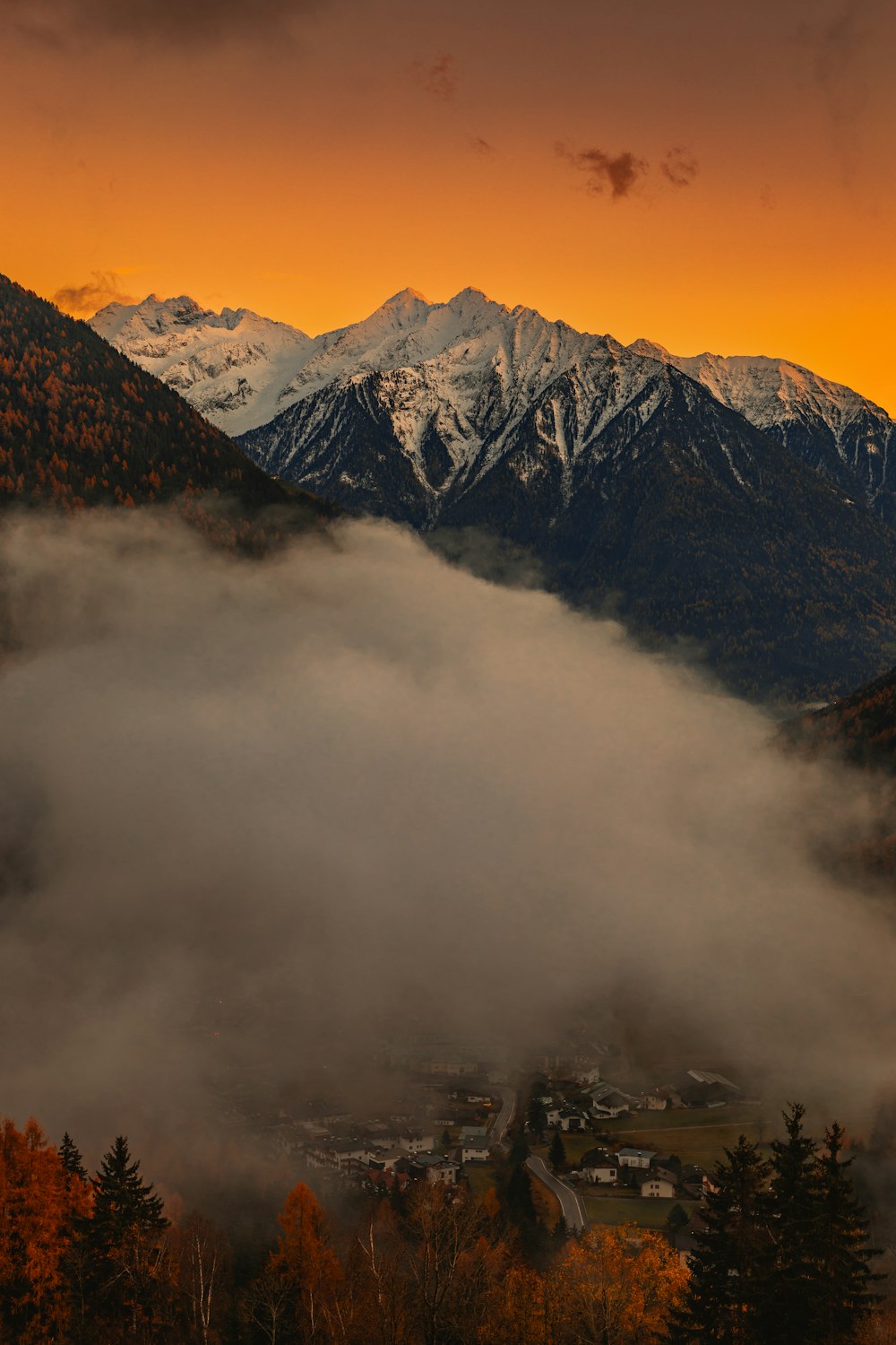 a view of a mountain range covered in clouds