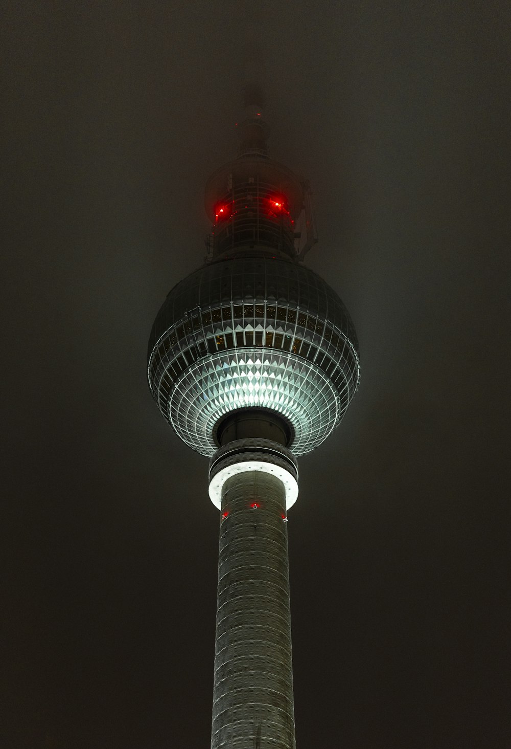 a tall tower with a red light on top of it