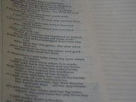 A close-up of a page from a book featuring text with religious or poetic content. The text is presented in a clear, serif font, and the page has a light beige background. The text includes verse numbers and appears to be structured in poetic lines.