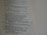 A close-up view of a page with religious text. The content includes verses and appears to be from a book or scripture, with neatly formatted lines and a structured layout.