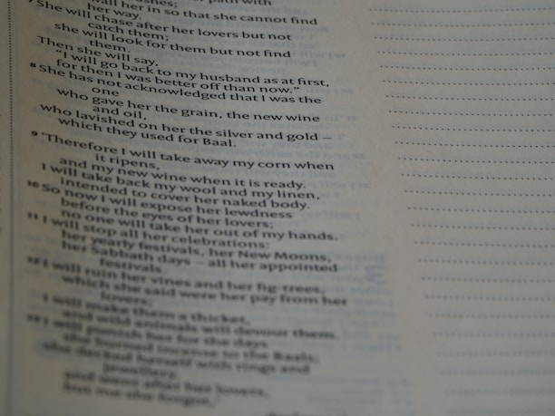 A close-up view of a page with religious text. The content includes verses and appears to be from a book or scripture, with neatly formatted lines and a structured layout.