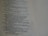 A close-up view of a page with religious text. The content includes verses and appears to be from a book or scripture, with neatly formatted lines and a structured layout.