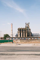 Field technician setting up air monitoring equipment near an industrial site