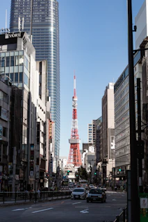 a red and white tower in the middle of a city
