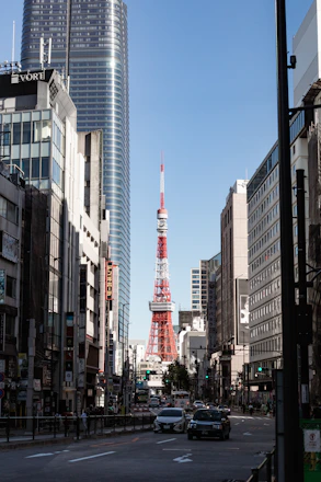 a red and white tower in the middle of a city
