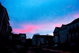 Evening view of Sunshine Bay Residence illuminated softly against the twilight sky.