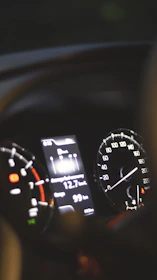 a car dashboard with a speedometer and other gauges