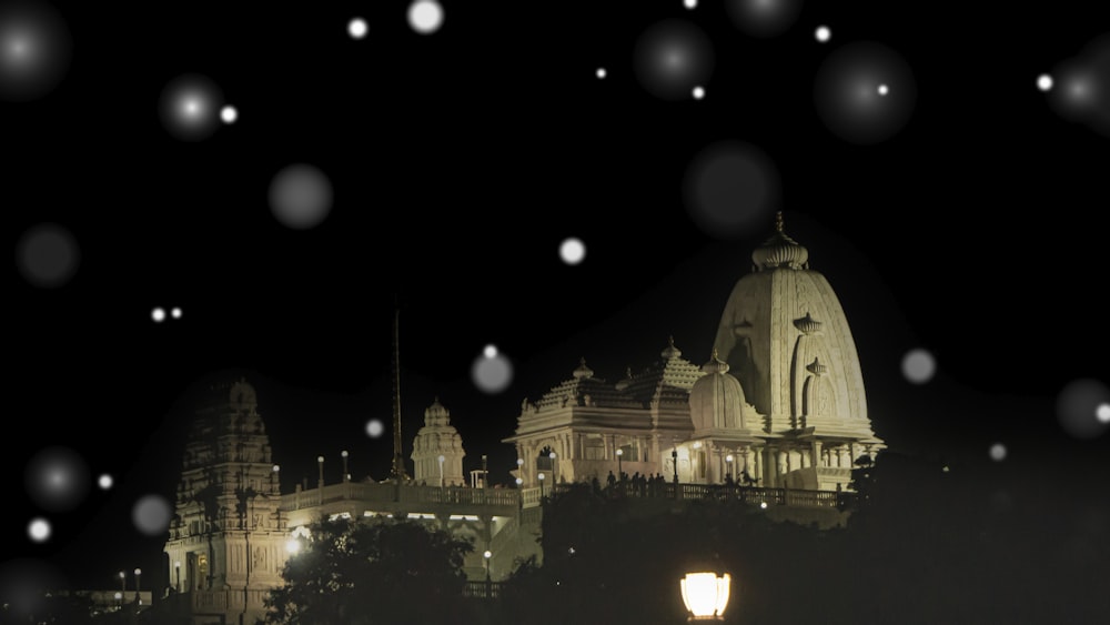 a night view of a building with snow falling on it