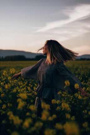 An outdoor session at dawn with participants spinning slowly against a soft pastel sky.