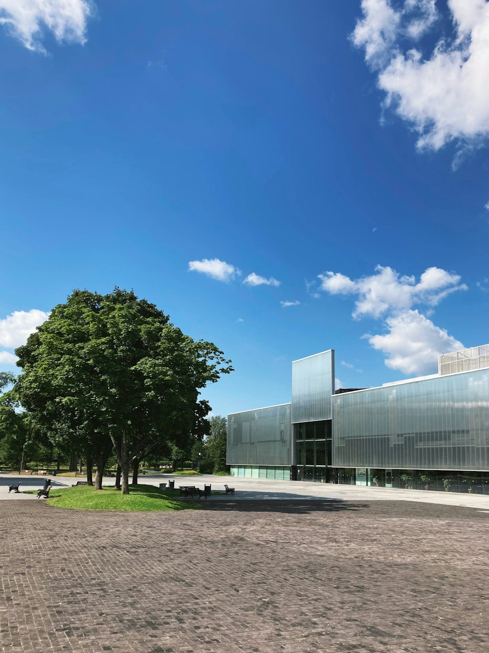 a large building sitting next to a tree on a field