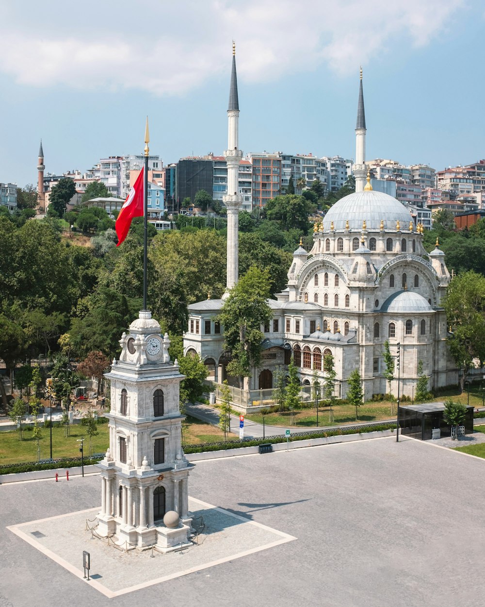 a large white building with a red flag in front of it