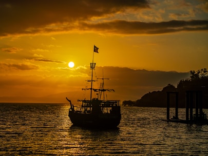 A calm sea with a rescue ship silhouette at sunset, symbolizing hope and safety.