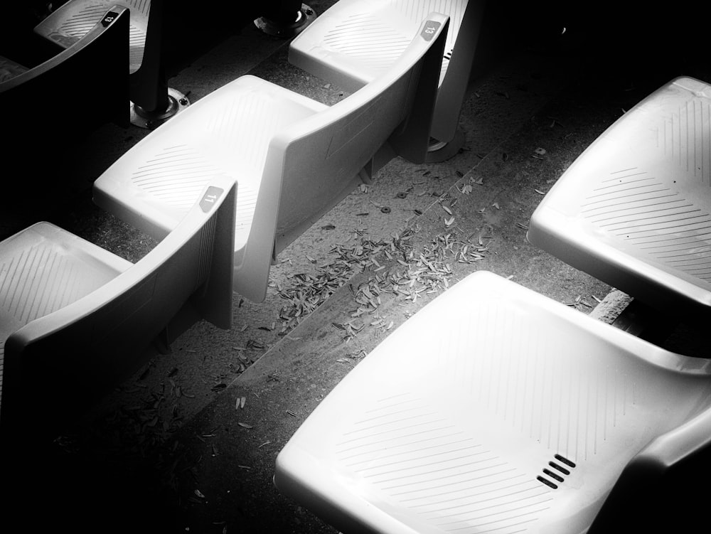 a group of white chairs sitting next to each other