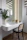 A cozy vanity setup with warm white and ivory tones, featuring be.calm products and soft natural light.