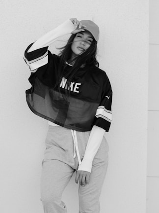 A model wearing a cap and oversized tee reflecting urban style.