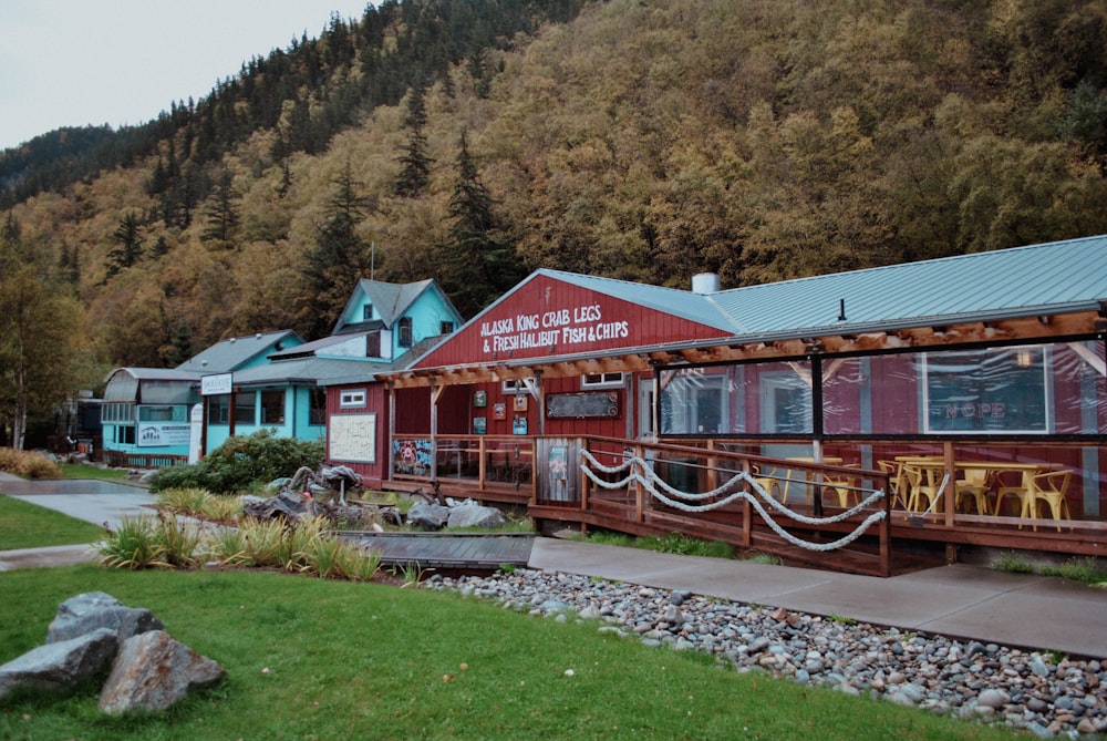 a red building sitting next to a lush green hillside