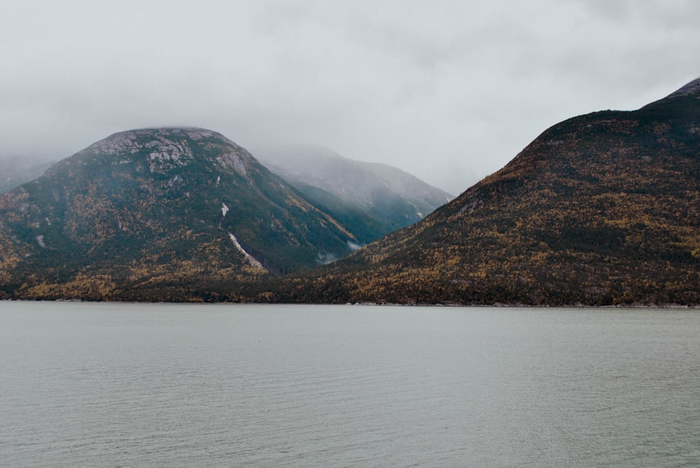 a body of water with mountains in the background