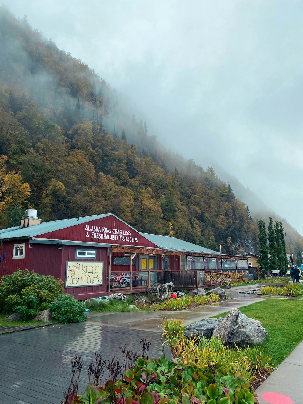 a red building with a mountain in the background