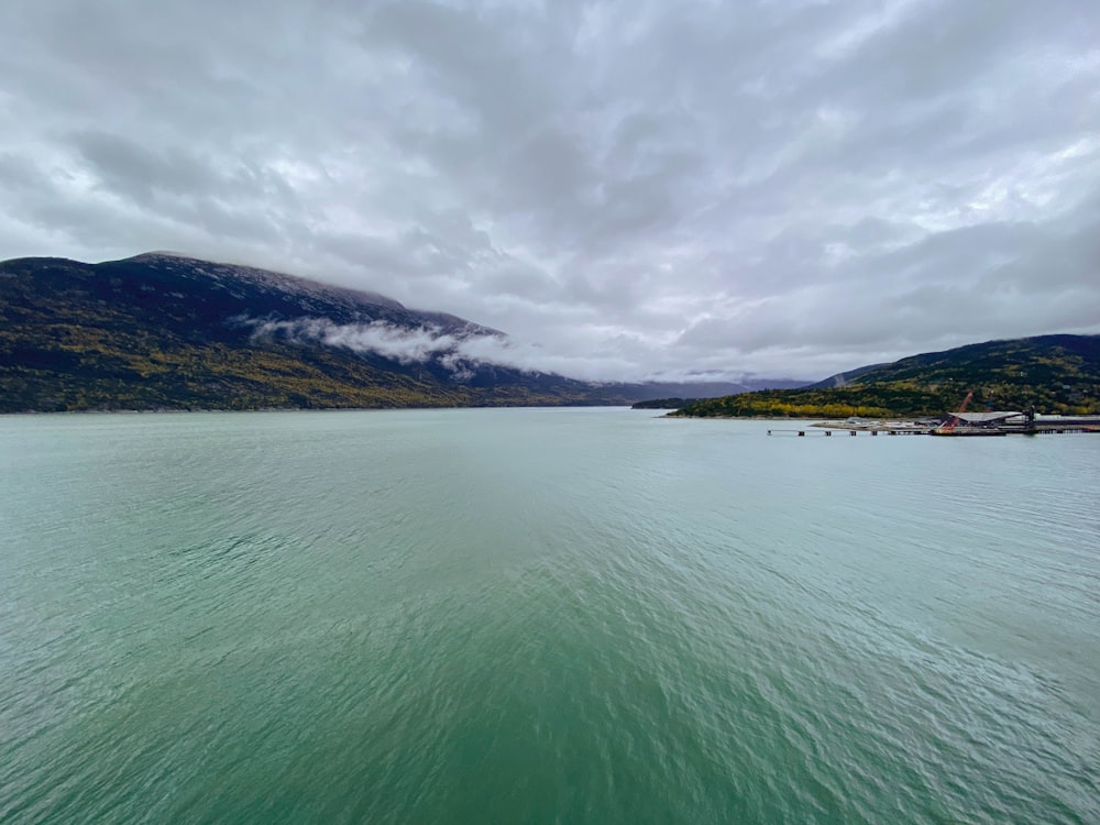 a body of water with mountains in the background