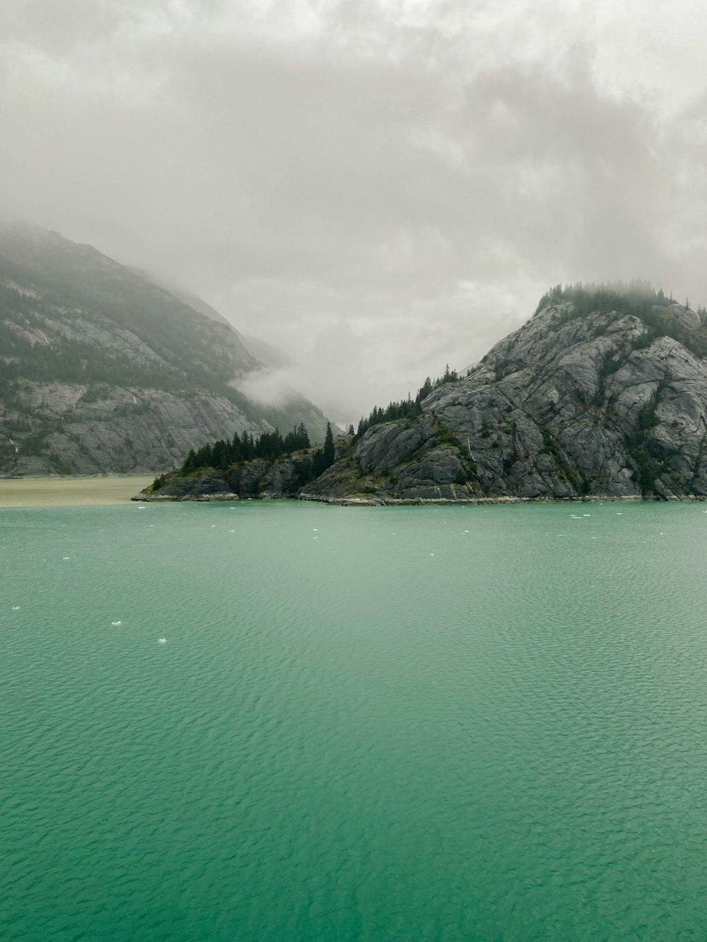 a body of water with a mountain in the background