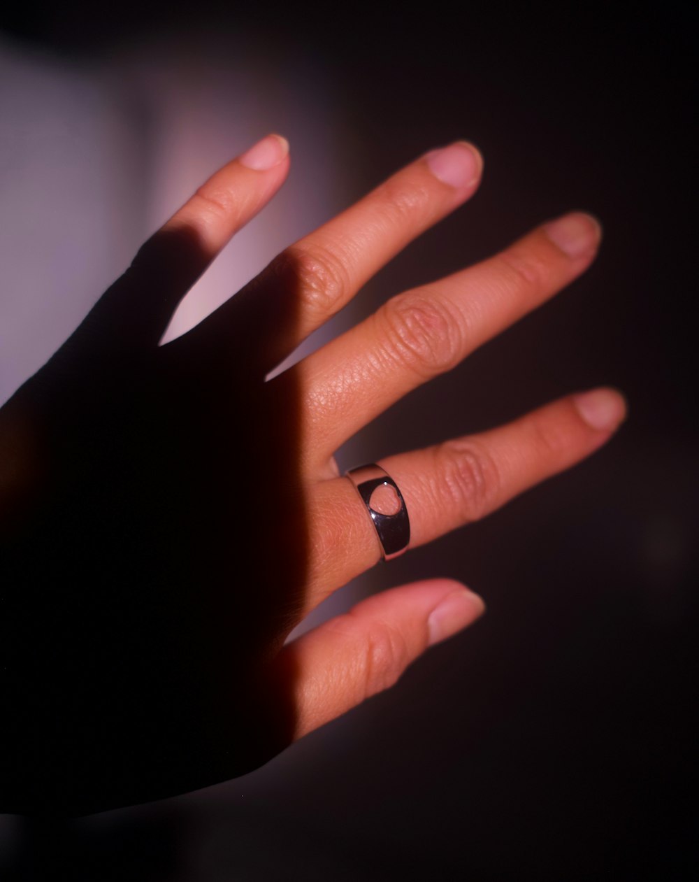 a person's hand with a ring on it