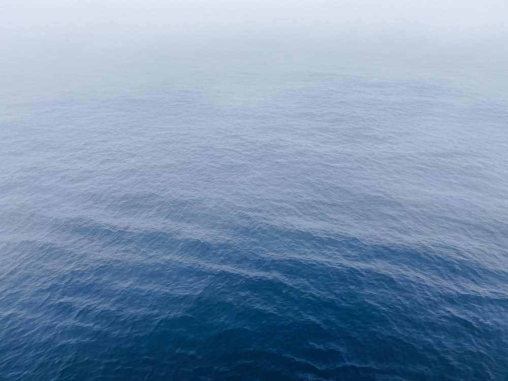 a large body of water with a sky background