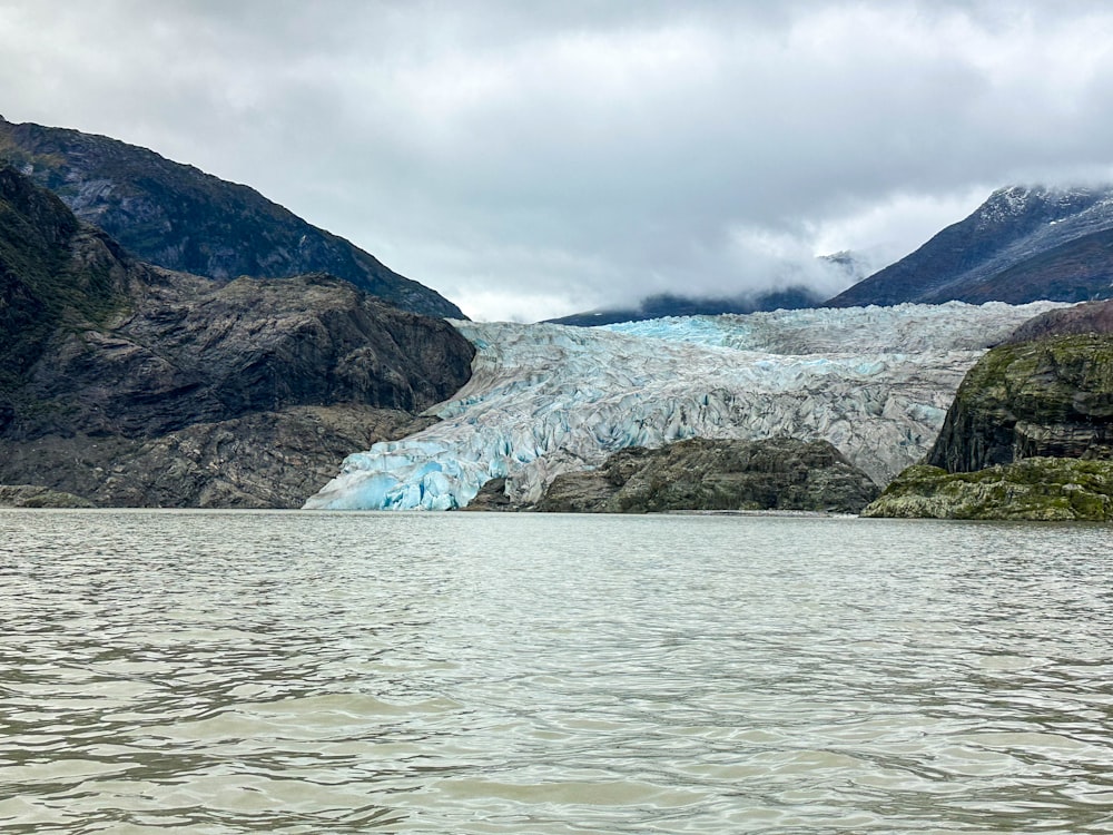 a large glacier in the middle of a body of water