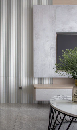 A cozy living room featuring a sleek TV wall with rounded corners and subtle wood accents.