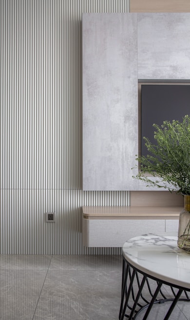 Elegant living room corner featuring a marmorato effect wall in soft neutral tones