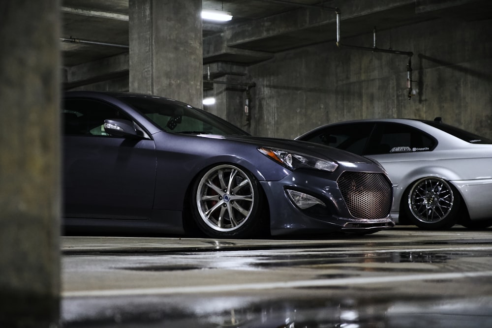 two cars parked in a parking garage next to each other