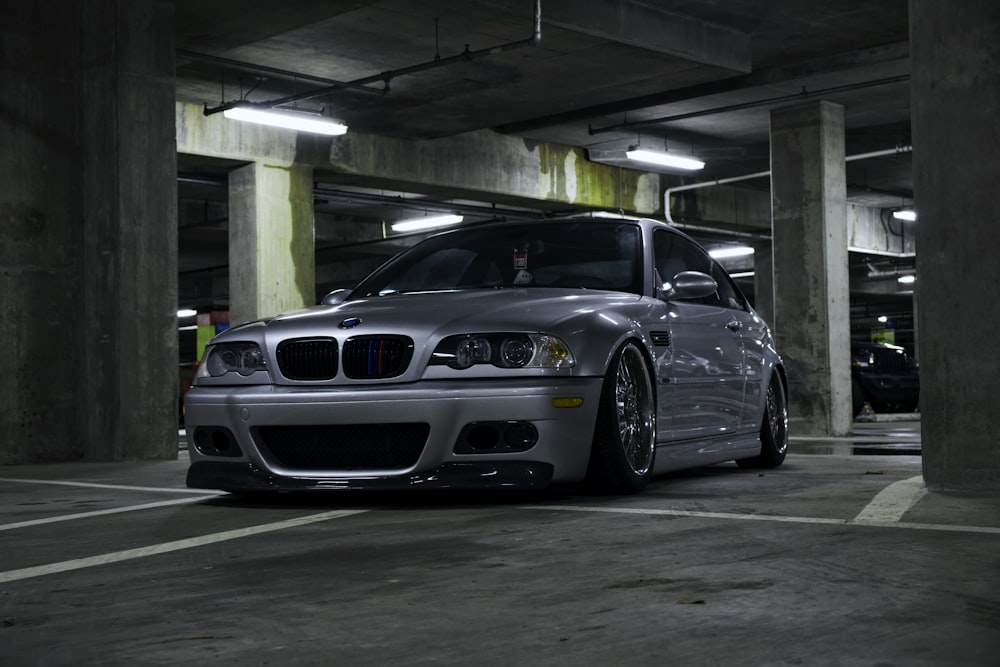 a silver car parked in a parking garage