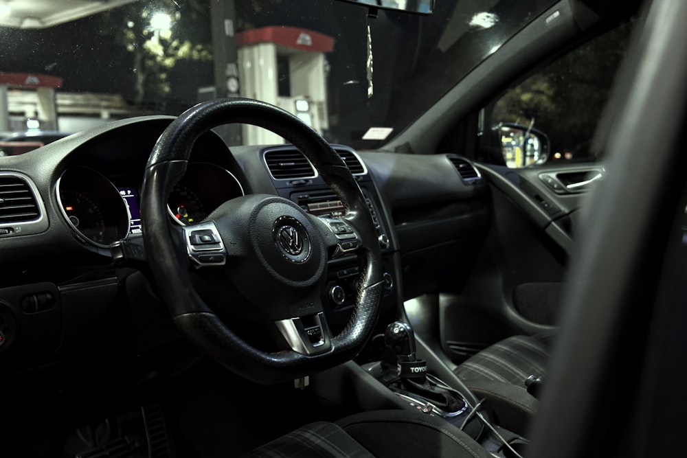 the interior of a car with a steering wheel and dashboard