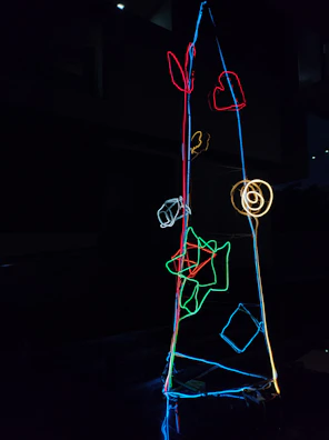 Artistic arrangement of personalized gifts featuring laser-cut details and neon highlights